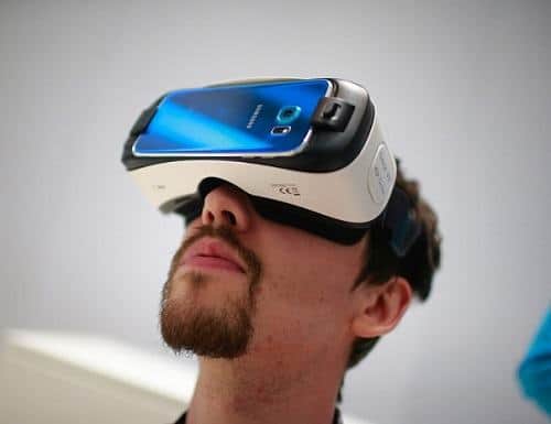 Man Using White Samsung Gear VR With Compatible Samsung Phone