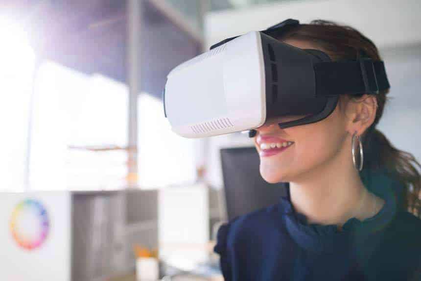 Female architect using virtual reality headset in office